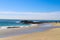 A beautiful shot of the gorgeous vast blue ocean water with people on the beach