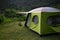 Beautiful shot of a green and gray tent in the field on the hill