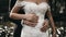 Beautiful shot of the groom holding the bride\'s belly. Pregnant wedding with a beautiful white dress