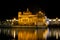 Beautiful shot of the Harmandir Sahib\'s building on a reflective lake foreground in India