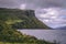 Beautiful shot of the historic Isle of Skye cliff over the water under a cloudy sky in Scotland