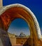 Beautiful shot of a house with an arched architecture and buildings in the distance