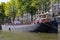 Beautiful shot of a houseboat sailing in a canal in Amsterdam the Netherlands