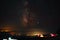 Beautiful shot of illuminated tents in a field under breathtaking sky full of stars