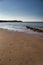 Beautiful shot of the Isle of Wight island with calm waves crashing on the sand under a blue sky