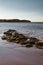 Beautiful shot of the Isle of Wight island with calm waves crashing on the sand under a blue sky