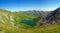 Beautiful shot of Lake Capra in the Fagaras Mountains on a bright day in Romania