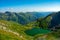 Beautiful shot of Lake Capra in the Fagaras Mountains on a bright day in Romania