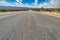 Beautiful shot of a long straight concrete road in between the desert field