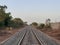 Beautiful shot from the middle of the railroad under the clear white sky