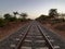 Beautiful shot from the middle of the railroad under the clear white sky