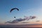 Beautiful shot of a paraglider silhouette flying over Monte Cucco Umbria, Italy with sunset on the background, with