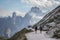 Beautiful shot of people hiking in the mountains In Three Peaks Nature Park In Toblach, Italy