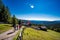 Beautiful shot of people walking on a dirt pathway with a view of Italian Alps and Dolomites