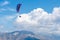 Beautiful shot of a person paragliding high in the sky above the mountains - extreme concept