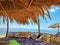 Beautiful shot of pillows and fabric cloth in a nipa hut cottage on the beach with a clear blue sky