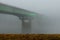Beautiful shot of a road bridge disappears into the fog across the Missouri river in Kansas City