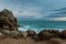 Beautiful shot of rocks on the seashore, mesmerizing blue seascape in the background