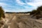 Beautiful shot of a sandy beach road on a cloudy sky background in Borkum, Germany