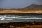 Beautiful shot of the sea and deserted lands in the distance in Fuerteventura,  Spain