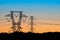 Beautiful shot of silhouettes of power lines during a sunrise