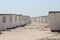 Beautiful shot of small white rooms near each other on a sandy surface under a cloudy sky