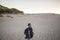 Beautiful shot of a smiling female walking on the beach at daytime