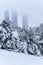 Beautiful shot of a snowy park with the Madrid four towers in the background