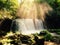 Beautiful shot of sun rays dropping on Choshi waterfall near Lake Towada in Aomori, Japan