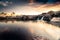 Beautiful shot of a sunset over a lake with a waterfall and rocky stones