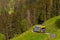 Beautiful shot of the Swiss Alps with a narrow road and yellow vehicle captured in Switzerland