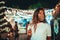 Beautiful shot of tanned European female wearing a floral mask at an amusement park