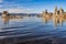 Beautiful shot of Tufa Towers with flock of birds flying above the water at Mono Lake, California