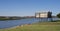 Beautiful shot of two riverside cabins under blue sky