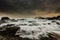 Beautiful shot of water flowing movement above rock formations under gray cloudy scenic sky