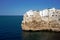 Beautiful shot of white buildings right on the shore of a sea