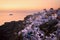 Beautiful shot of white buildings of Santorini, Greece, near the sea during the sunset