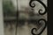 Beautiful shot of a window with raindrops and patterns and a small insect on a blurred background