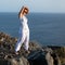 Beautiful shot of a woman standing near a cliff in La Palma island, Spain