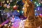 Beautiful shot of a wooden handmade horse on the blurred Christmas tree background