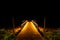 Beautiful shot of a wooden pier illuminated by light at night