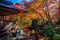 Beautiful shrine surrounded by vibrant fall foliage near a pond
