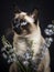 Beautiful siamese cat with blue eyes and light blue flowers, pet portrait