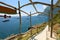 Beautiful sight of Capri bay with yachts from wooden archways, Italy