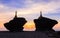 Beautiful silhouette of pagodas on rocks at sea during sunset twilight
