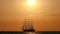 Beautiful silhouette sailing vessel in the sea. three-masted ship floats on the high seas at sunset