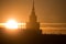 A beautiful silhouette of a tower in city during the sunrise. Morning scenery of Riga, Latvia. Tall building in city.