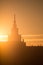 A beautiful silhouette of a tower in city during the sunrise. Morning scenery of Riga, Latvia. Tall building in city.