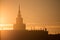 A beautiful silhouette of a tower in city during the sunrise. Morning scenery of Riga, Latvia. Tall building in city.