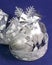 Beautiful silvery New Year`s ball, brilliant tinsel on a blue background - New Year`s composition, a card